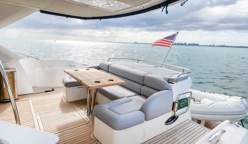 Ohana Yacht Photos Pics Luxurious 2016 Sunseeker Manhattan 55 yacht deck with seating, table, and ocean view.