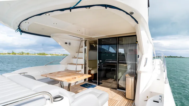 Ohana Yacht Photos Pics Luxurious 2016 Sunseeker Manhattan 55 yacht with elegant outdoor seating and ocean view.