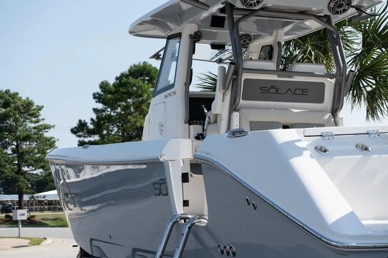  Yacht Photos Pics 2025 Solace 32 CS boat, sleek design, parked outdoors with trees in the background.