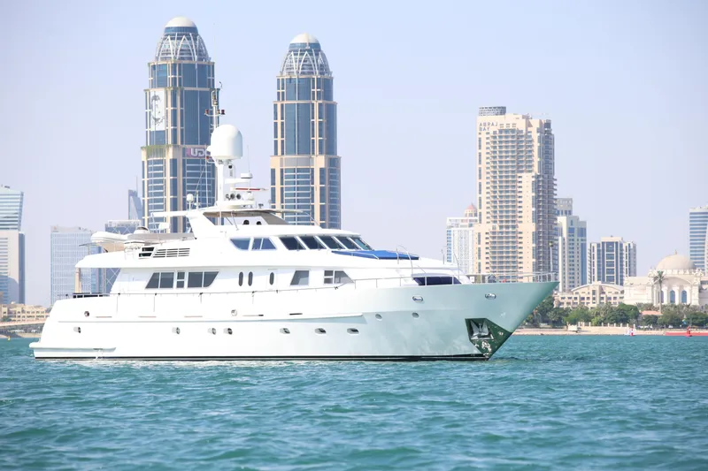  Yacht Photos Pics Luxury yacht Codecasa 105 Custom (1999) cruising near modern city skyline.