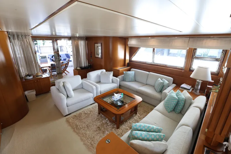  Yacht Photos Pics Luxurious interior of 1999 Codecasa 105 Custom yacht with elegant seating and wooden accents.