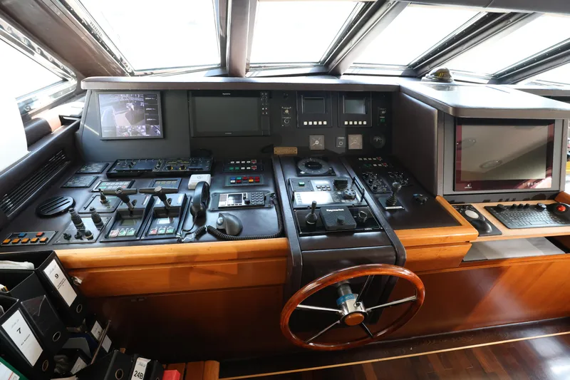  Yacht Photos Pics Control panel of 1999 Codecasa 105 Custom yacht with steering wheel and navigation equipment.