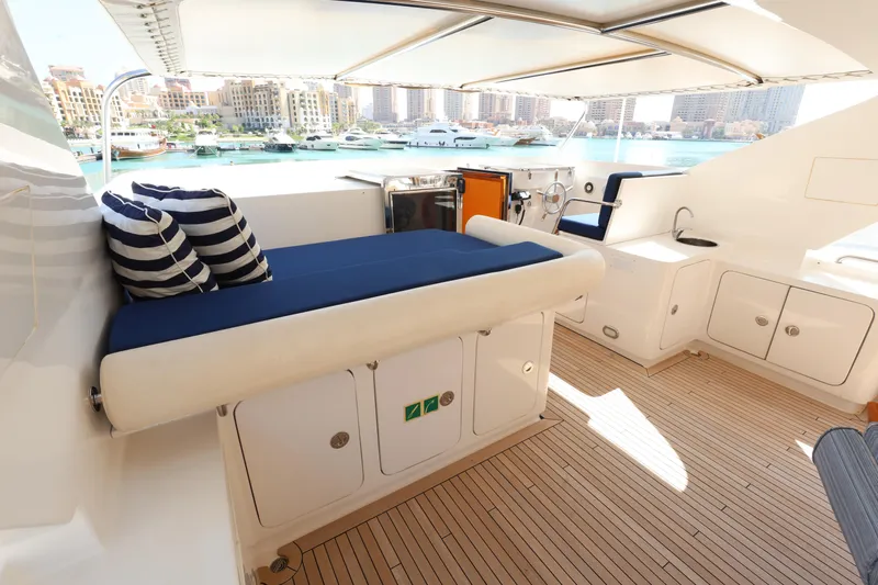  Yacht Photos Pics Luxurious Codecasa 105 Custom yacht deck with seating, cushions, and waterfront view, 1999 model.