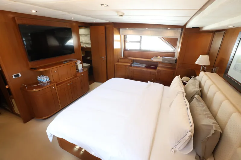  Yacht Photos Pics Luxurious bedroom interior of 1999 Codecasa 105 Custom yacht with elegant wood finishes.