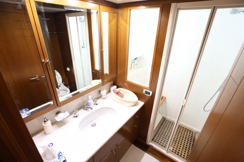  Yacht Photos Pics Luxurious bathroom in 1999 Codecasa 105 Custom yacht with wooden cabinetry and modern shower.