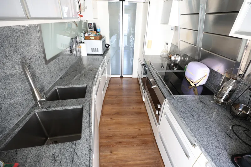  Yacht Photos Pics Luxurious kitchen in 1999 Codecasa 105 Custom yacht with granite countertops and modern appliances.