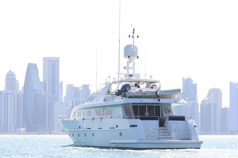  Yacht Photos Pics Luxurious 1999 Codecasa 105 Custom yacht cruising near a modern city skyline.