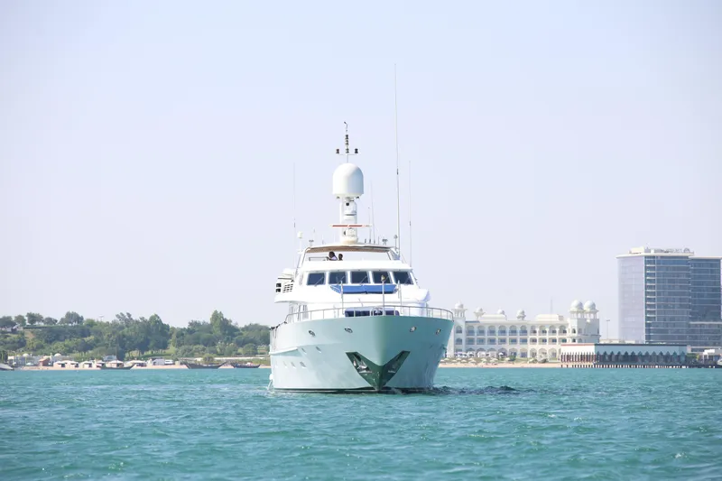  Yacht Photos Pics Front view of 1999 Codecasa 105 Custom yacht on calm water near a coastal city.