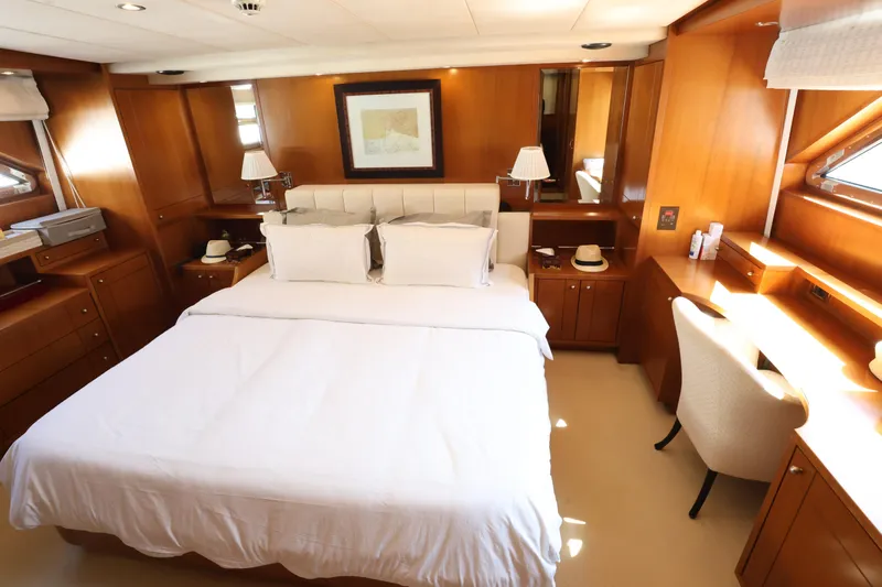  Yacht Photos Pics Luxurious bedroom interior on 1999 Codecasa 105 Custom yacht with elegant wood paneling.