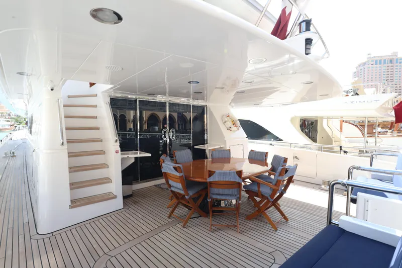  Yacht Photos Pics Luxurious 1999 Codecasa 105 Custom yacht deck with dining area and staircase.