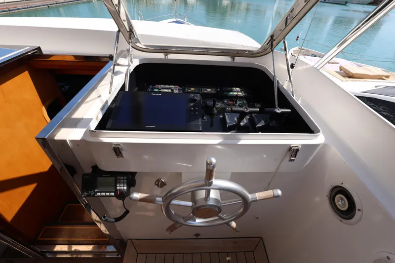  Yacht Photos Pics Control panel of 1999 Codecasa 105 Custom yacht with steering wheel and navigation equipment.