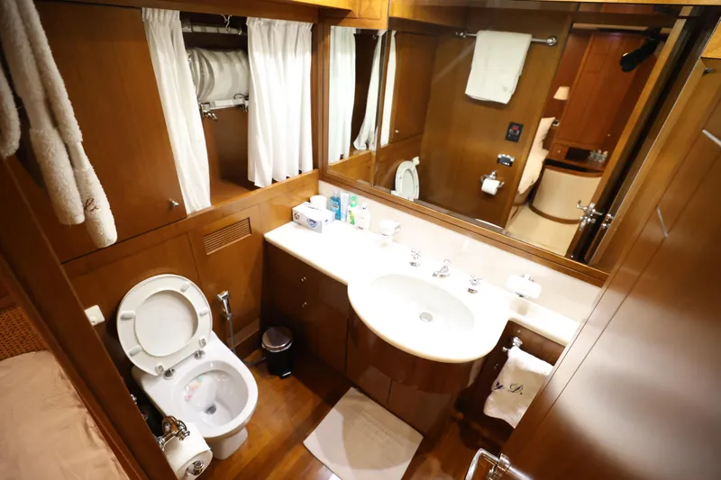  Yacht Photos Pics Luxurious bathroom on 1999 Codecasa 105 Custom yacht with wood accents and modern amenities.