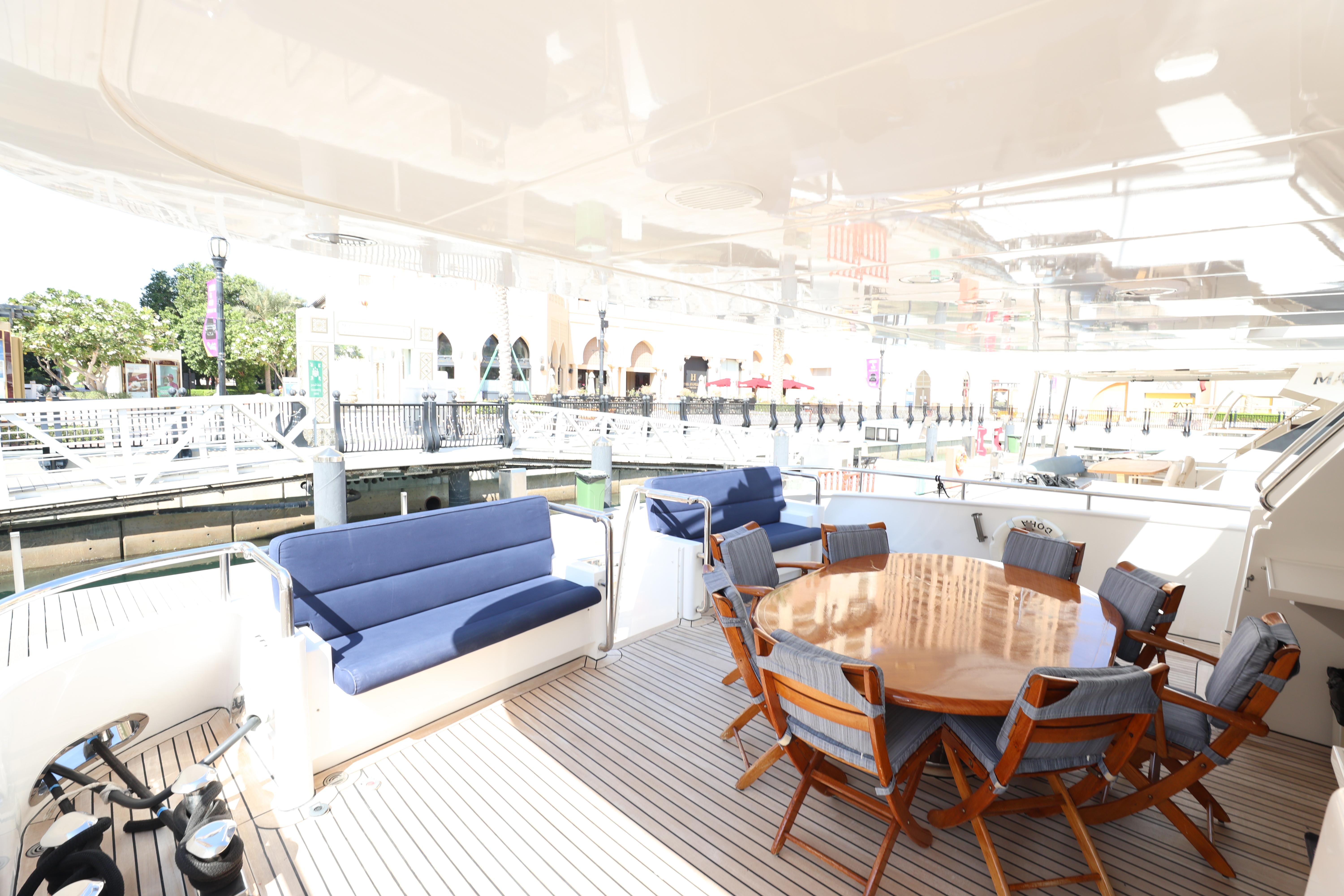 Luxurious Codecasa 105 Custom yacht deck with seating and dining area, 1999 model.