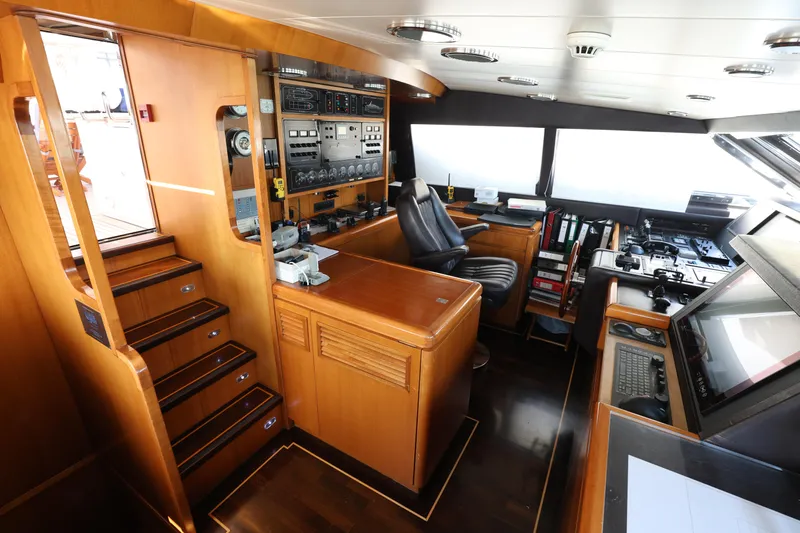  Yacht Photos Pics Bridge interior of 1999 Codecasa 105 Custom yacht, featuring control panels and navigation equipment.