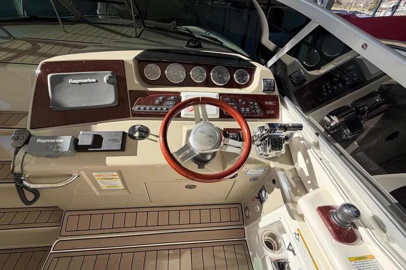  Yacht Photos Pics 2014 Sea Ray 370 Sundancer helm with Raymarine electronics and wood-accented steering wheel.