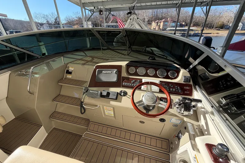  Yacht Photos Pics 2014 Sea Ray 370 Sundancer helm with wood accents and modern navigation equipment.