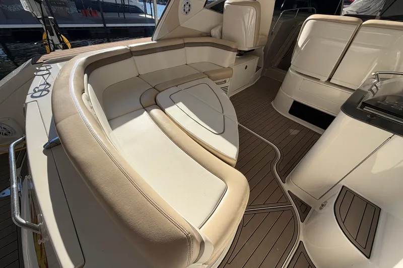 Yacht Photos Pics Luxurious interior of 2014 Sea Ray 370 Sundancer yacht with elegant seating and wood flooring.