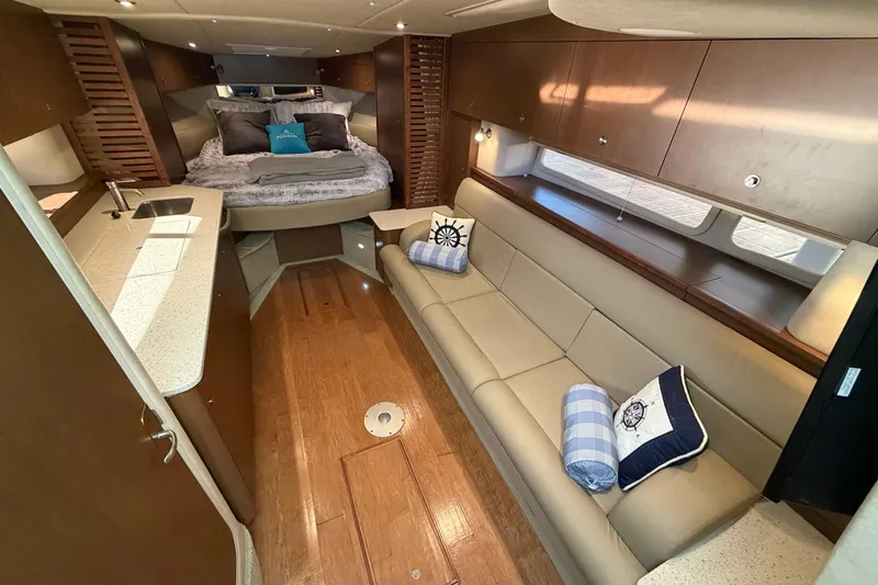 Yacht Photos Pics Luxurious interior of 2014 Sea Ray 370 Sundancer yacht with cozy seating and elegant design.