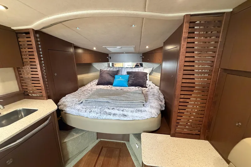  Yacht Photos Pics Luxurious interior of 2014 Sea Ray 370 Sundancer with cozy bed and modern amenities.