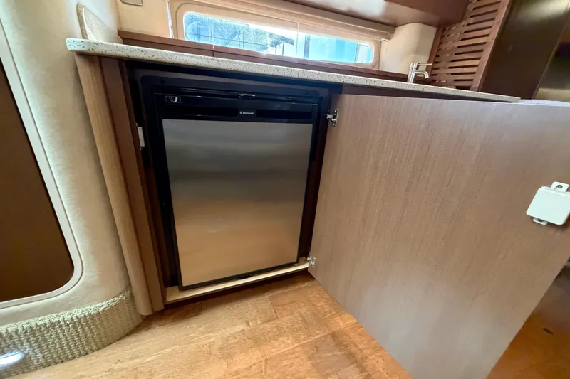  Yacht Photos Pics Interior of 2014 Sea Ray 370 Sundancer showing a compact stainless steel refrigerator.