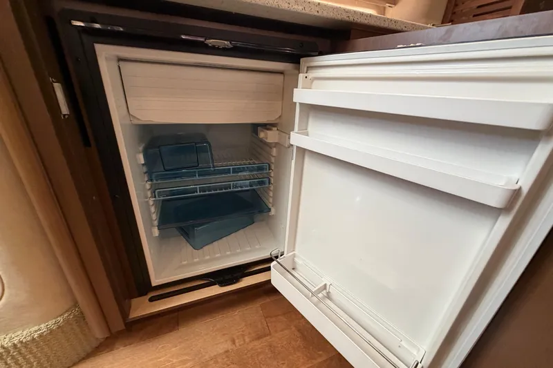  Yacht Photos Pics Open refrigerator inside 2014 Sea Ray 370 Sundancer yacht, showcasing interior storage space.