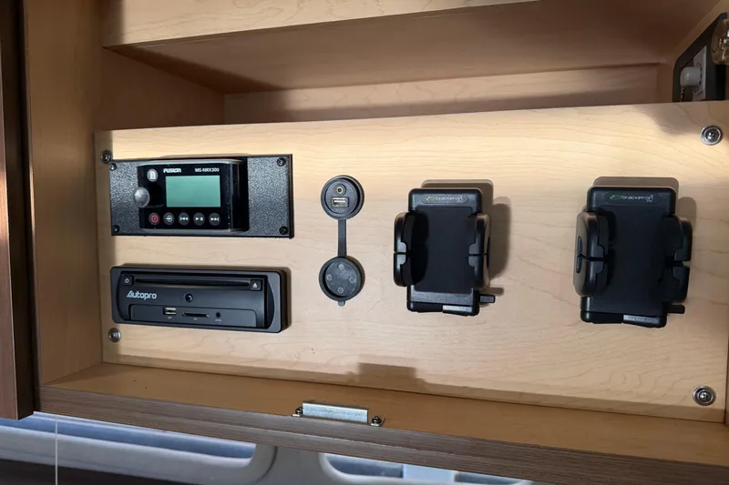  Yacht Photos Pics Control panel inside 2014 Sea Ray 370 Sundancer, featuring electronic devices and holders.