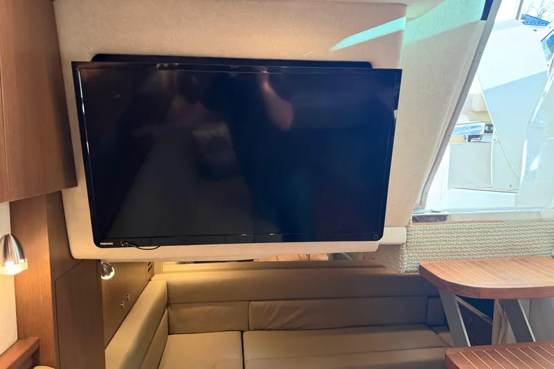  Yacht Photos Pics Interior of 2014 Sea Ray 370 Sundancer with TV and seating area.