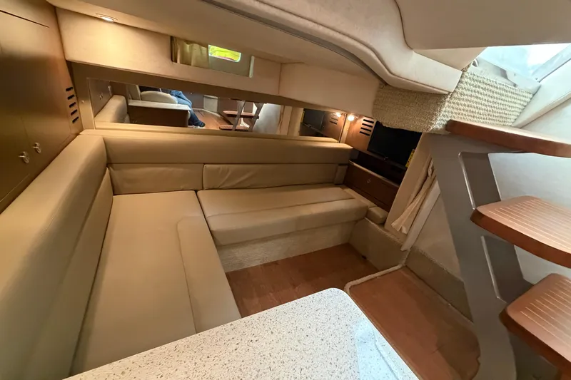  Yacht Photos Pics Interior of 2014 Sea Ray 370 Sundancer with beige seating and wooden stairs.