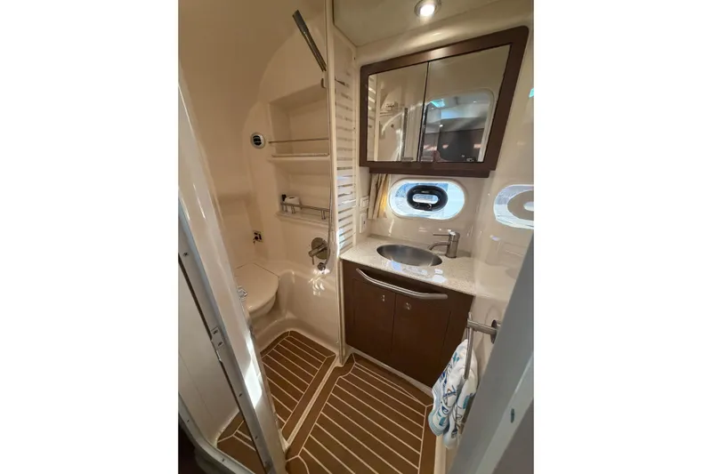  Yacht Photos Pics Luxurious bathroom in 2014 Sea Ray 370 Sundancer yacht with modern fixtures and wood accents.