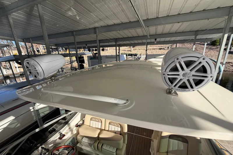  Yacht Photos Pics 2014 Sea Ray 370 Sundancer with mounted speakers on deck under covered dock.