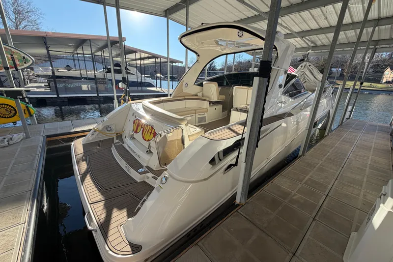  Yacht Photos Pics 2014 Sea Ray 370 Sundancer docked in a marina under a covered slip.