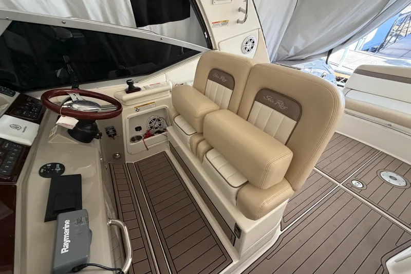  Yacht Photos Pics 2014 Sea Ray 370 Sundancer helm with beige seating and wood-accented steering wheel.