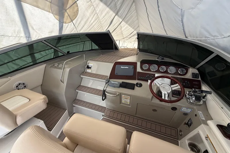  Yacht Photos Pics 2014 Sea Ray 370 Sundancer helm with modern controls and beige seating under a canopy.
