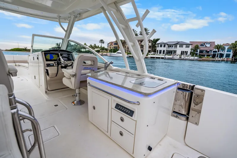  Yacht Photos Pics 2018 Boston Whaler 320 Vantage boat interior with helm and waterfront view.