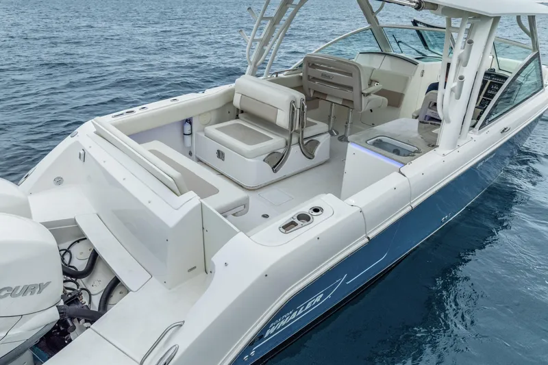  Yacht Photos Pics 2018 Boston Whaler 320 Vantage boat on water, showcasing spacious deck and seating.
