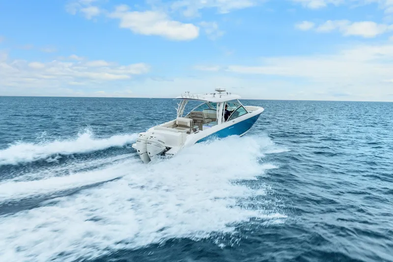  Yacht Photos Pics 2018 Boston Whaler 320 Vantage cruising on open ocean under blue sky.