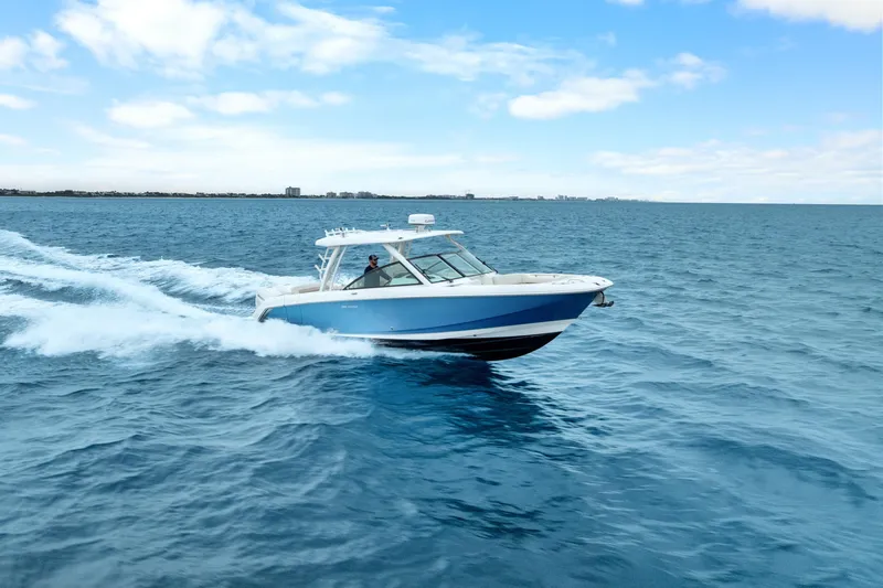  Yacht Photos Pics 2018 Boston Whaler 320 Vantage cruising on open blue ocean under clear sky.