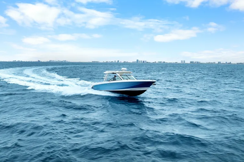  Yacht Photos Pics 2018 Boston Whaler 320 Vantage cruising on open ocean under clear blue sky.
