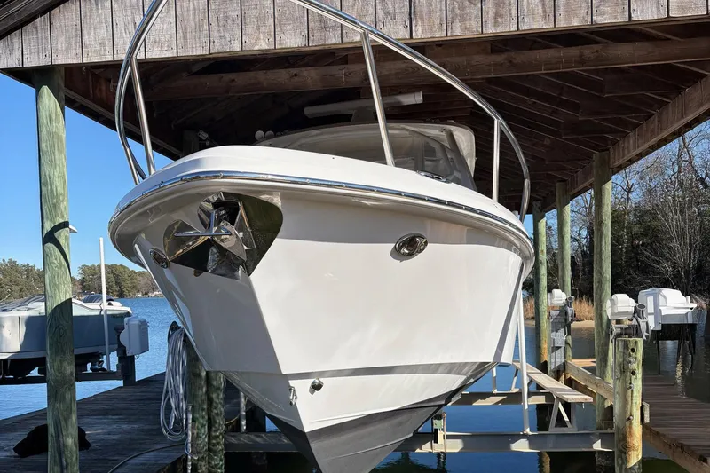 In Absentia Yacht Photos Pics 2017 Everglades 350LX boat docked under wooden shelter by the water.