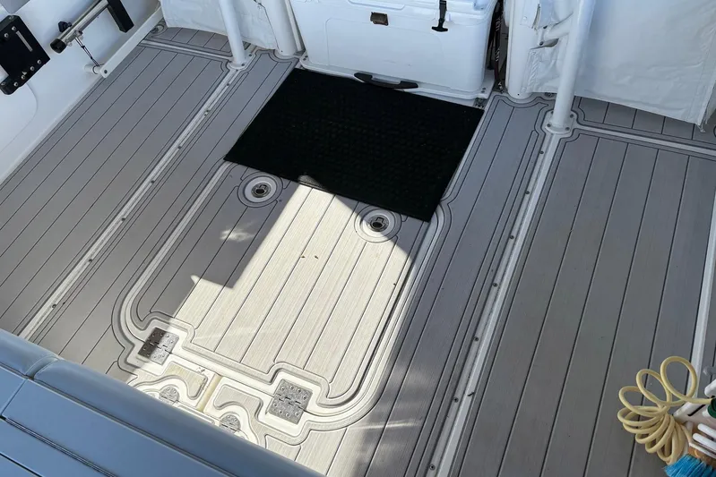 In Absentia Yacht Photos Pics 2017 Everglades 350LX boat deck with non-slip flooring and storage compartments.