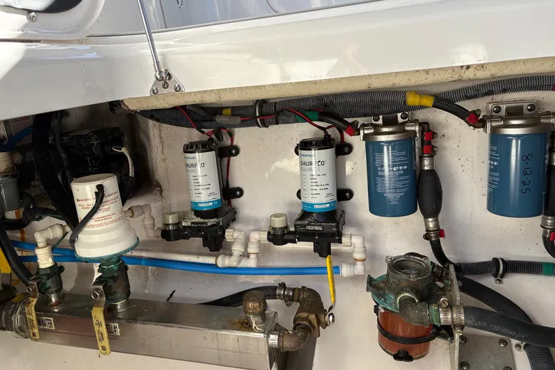 In Absentia Yacht Photos Pics Engine compartment of a 2017 Everglades 350LX boat, showcasing pumps and filters.