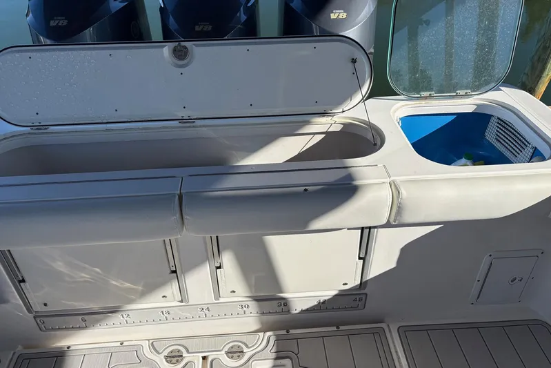 In Absentia Yacht Photos Pics 2017 Everglades 350LX boat deck with storage compartments and V8 engines.