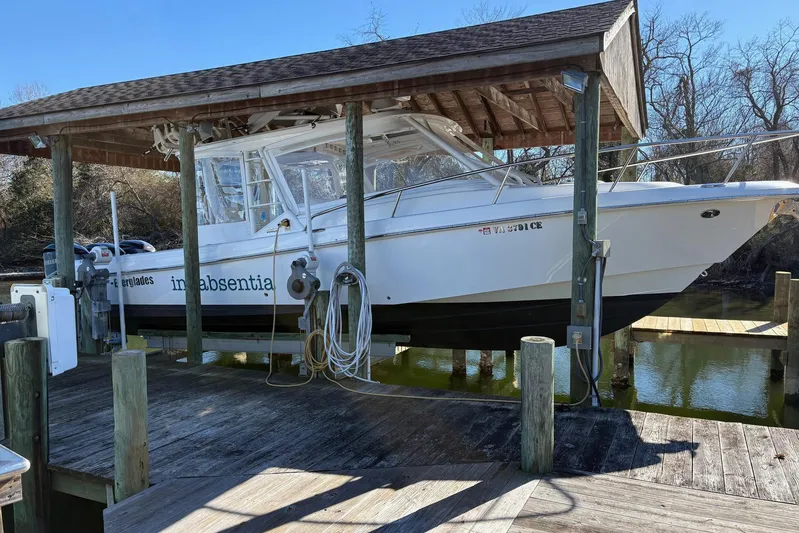 In Absentia Yacht Photos Pics 2017 Everglades 350LX boat docked under a wooden shelter.