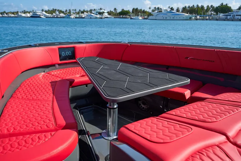  Yacht Photos Pics Luxurious 2021 Midnight Express 43' Solstice boat with red seating and sleek table on water.