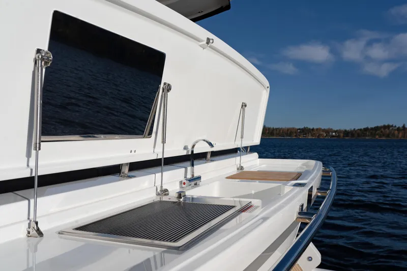  Yacht Photos Pics 2024 Galeon 440 Fly yacht with outdoor kitchen, featuring grill and sink, on open water.