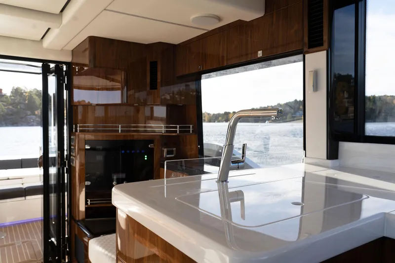  Yacht Photos Pics Luxurious interior of 2024 Galeon 440 Fly yacht with modern kitchen and scenic water view.