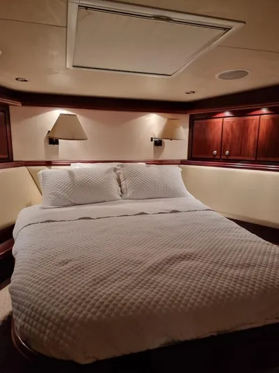  Yacht Photos Pics Luxurious bedroom in a 2009 Bertram 700 Enclosed yacht with cozy lighting.
