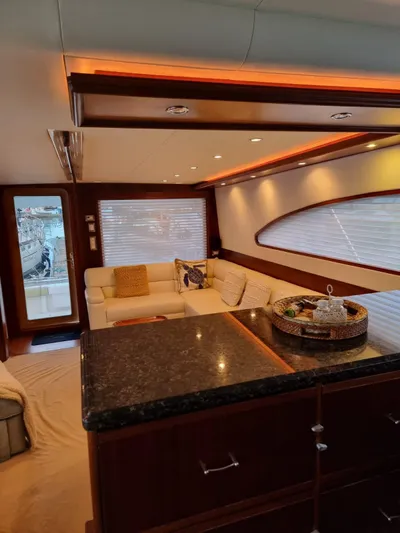  Yacht Photos Pics Luxurious interior of 2009 Bertram 700 Enclosed yacht with modern furnishings and ambient lighting.