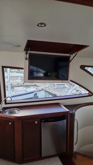  Yacht Photos Pics Interior of 2009 Bertram 700 Enclosed yacht with TV, sink, and mini-fridge.