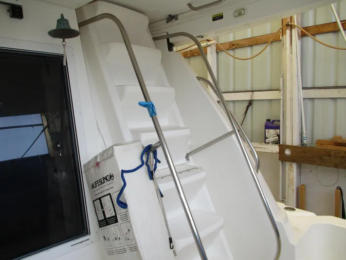 Spice Yacht Photos Pics Staircase on 2000 Bayliner 5288 Pilot House yacht with metal railings and storage area.